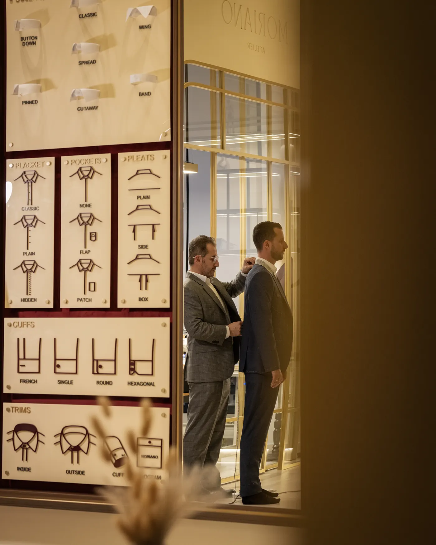 A tailor taking precise measurements at the atelier