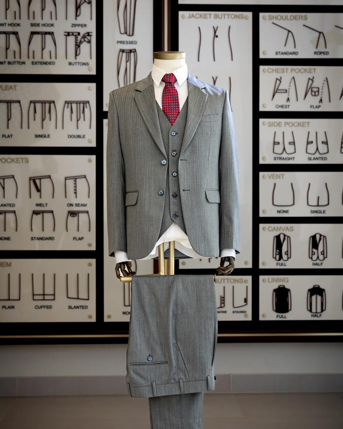 A bespoke three-piece suit on the tailor's form