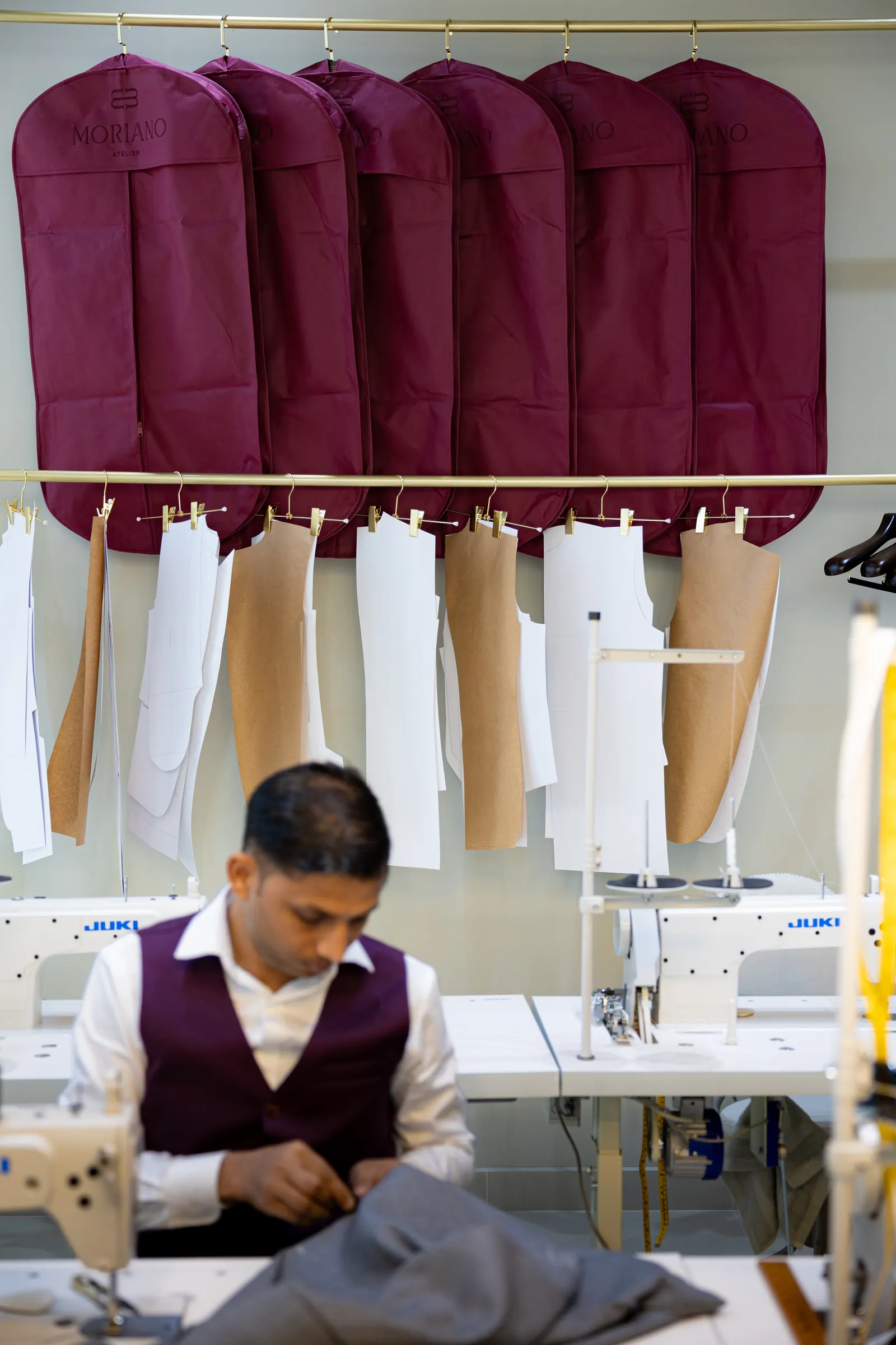 A MORIANO tailor shaping a jacket on the form